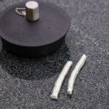 Two replacement wicks for SACKit Oil Lamp, thin cylindrical shape, white color, packaged together.