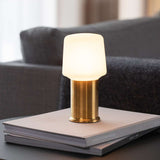 Brushed brass London base for Lamp Intelligent with a sleek industrial design in outdoor setting