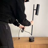 Black Expo Table lamp with aluminum body and polished marble base on a light background.