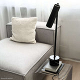Black Expo Table lamp with aluminum body and polished marble base on a white background.