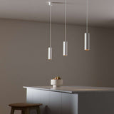 White Expo Pendant light with aluminum shade and long white cord hanging indoors