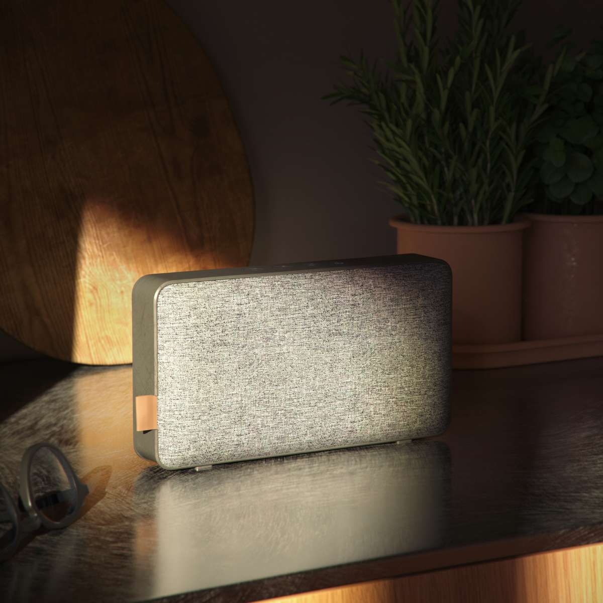 Grey Move 50 Care Bluetooth speaker with biodegradable frame and silicone buttons on a white background