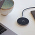 Compact square wireless charger with gray Revive fabric and aluminum frame on white background