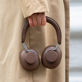 Brown over-ear Touch 310 headphones with cushioned ear cups and adjustable headband on white background.