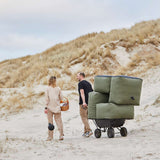 Soft Sofa Outdoor 2-seater in Kirra Olive fabric placed outdoors on a wooden deck.