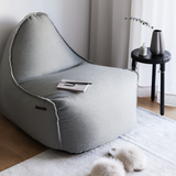 Medley Lounge Chair in Medley Grey fabric with soft, rounded shape and backrest on a white background