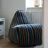 Lounge Chair Paul Smith with multicolored linear cotton upholstery in a modern living room setting