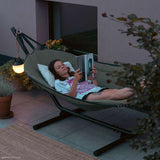 Cobana Hammock in grey olefin fabric with black powder-coated aluminum stand outdoors.