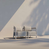 Kirra Lounge Sofa corner module in Kirra Sand with powder-coated aluminum frame and Olefin textile cushions outdoors.
