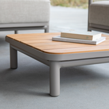 Taupe Kirra Side Table with teak wood top and powder-coated aluminum frame for outdoor use.