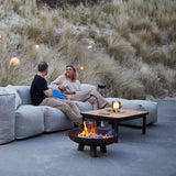 Kirra Coffee Table in black powder-coated aluminum with teak wood top, outdoor setting.