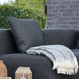 Black Cobana Cushion with water-repellent Olefin fabric for outdoor sofa seating.