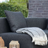 Black Cobana Cushion made of water-repellent Olefin fabric for outdoor sofa seating.