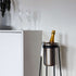 Satin polished stainless steel wine cooler with leather handle and included ice tong on a white background