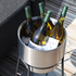 Black powder-coated steel patio accessory stand with stainless steel wine bucket on top