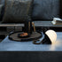 SACKit Light 155 outdoor lamp with a white dome and hemp rope handle on a wooden surface.