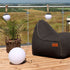 SACKit Light 250 outdoor lamp with a round white dome and hempen rope handle on a wooden surface