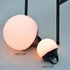 Round SACKit Light 250 outdoor lamp with a white dome and hemp rope handle on a wooden surface