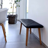 Nordic Bench in solid oak with Terra Black leather seat, sleek and minimalist design.