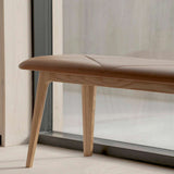 Nordic Bench with Terra Black leather seat and solid oak wood frame in a modern setting
