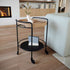 Matte black powder-coated steel Serving Table with four wheels and minimalist design on a white background