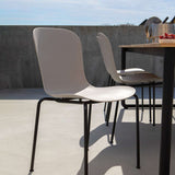 Taupe outdoor dining chair with black powder-coated steel frame and recycled plastic shell.