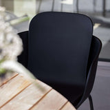 Taupe and black Patio Chair no. One S2 with two-shell design and black powder-coated steel frame outdoors