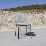 Patio Chair no. One with taupe recycled plastic shell and black powder-coated steel frame with full sand melange cushion outdoors.