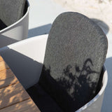 Taupe outdoor dining chair with black powder-coated steel frame and full black cushion
