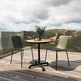 Olive green molded plastic patio chair with black powder-coated steel frame on outdoor terrace
