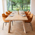 Edge Dining Table made of European oak with detailed facets and natural wood finish in a bright room.