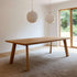 Edge Dining Table made of European oak with detailed facets and natural wood finish in a bright room.