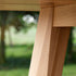 Edge Dining Table made of European oak with detailed facets and natural wood finish in a bright room setting