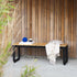 Outdoor patio bench with powder-coated aluminum frame and teak wood seat, 130x37 cm.