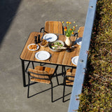 Kirra Dining Table 150x90 outdoor table with teak wood top and powder-coated aluminum frame in natural setting