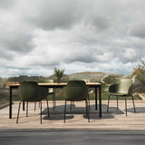 Outdoor Kirra Dining Table with teak wood top and powder-coated aluminum frame in a natural setting