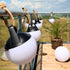 Three SACKit Light 150 outdoor lamps with white domes and hempen rope handles arranged together.