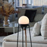 Black powder-coated stainless steel Patio Accessory Stand with a white Light 155 lamp on top outdoors