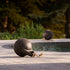Black powder-coated stainless steel Patio Accessory Stand with SACKit Play speaker on top outdoors