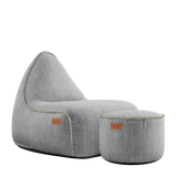 Cobana Lounge Chair and Pouf in Cobana Sand Melange with soft fabric texture and rounded shapes.