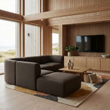 sackit fjord corner sofa with open end in dark brown fabric arranged in a warm Scandinavian living room beside large windows and a wooden media wall