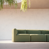 Left corner section of Fjord Sofa in Cosmo Olive fabric with rounded edges and soft design.