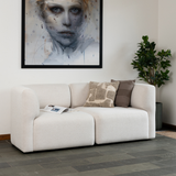 Two-seater Fjord Sofa in light fabric with rounded edges and soft lines in a bright room setting