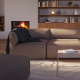 Left corner section of Fjord Sofa in a neutral indoor setting with soft rounded edges and textured upholstery