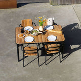 sackit Kirra outdoor dining set with a wooden table and four patio chairs set for an alfresco meal in a sunny garden space