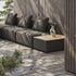 sackit outdoor modular sofa with cushions beside a wood topped patio storage table on a Nordic deck