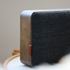 Bluetooth speaker with natural oak wood and Fiord textile from KVADRAT in a minimalist design.