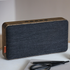 Move Wood Bluetooth speaker in natural oak with Fiord textile and brass details on a light surface