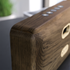 Move Wood Bluetooth speaker in natural oak with Fiord textile and brass details on a white background.
