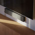 Sleek soundbar with textile front and ABS plastic body in a modern home setting